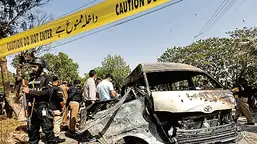 Police officers and crime scene unit gather near a passenger van, after a blast at the entrance of the Confucius Institute, University of Karachi, Pakistan April 26, 2022 (REUTERS)