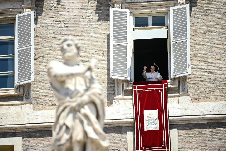 Pope Francis leads his Sunday Angelus prayer from the window of his office overlooking Saint Peter